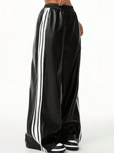 Black satin wide-leg pants featuring three bold white vertical stripes suitable for tumble dry care