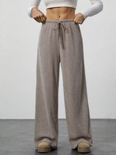Beige ribbed knit wide leg pants with drawstring waist in a relaxed fit design for comfortable leg pants wear