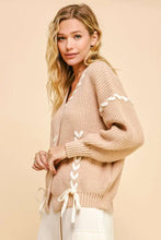 Beige chunky knit cardigan with lace-up ribbon bow and bishop sleeves
