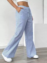 Light blue and white striped wide leg pants with a drawstring waist in a comfortable wide leg design