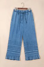 Light blue chambray pants with wide leg fit ruffled hem and elastic drawstring waist for comfortable wear