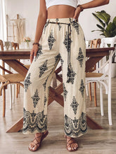 Beige boho print wide leg pants with black floral embroidery and lace trim at the hem for a stylish look