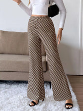 Brown and beige plaid high-waisted wide leg pants made from soft material with easy care instructions visible