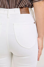 White high-rise denim judy blue capri pants with extended waistband and brown leather brand patch at waistband