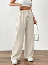 Beige casual drawstring wide leg pants with elastic waistband made of textured fabric for comfortable wear