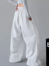 White oversized wide leg drawstring pants with elastic waistband and side pockets in loose fitting wide leg style