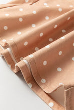 Soft peach polka dot print drawstring wide leg pants with white dot print and textured fabric with stitched seams