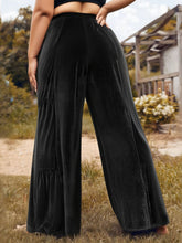 Plus size velvet ruffle hem wide leg pants in black velvet with tiered ruffle hem detail for elegant wear
