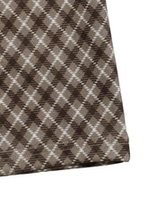 Plaid high-waisted wide leg pants in brown and white argyle patterned woven fabric with care instructions on material composition