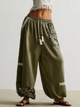 Olive green lace detail drawstring harem pants with wide-leg cut and lace on pockets and hem for stylish comfort