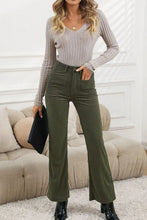 Olive green high waist square pockets corduroy pants in flare style with textured fabric and functional design