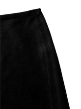 High waist velvet flare pants in black velvet with smooth plush texture and subtle vertical stitching along the seam