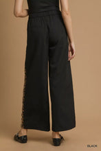Umgee front pleated black wide-leg pants offer leopard print contrast trim for a stylish and comfortable look