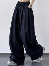 Black wide-leg pants with elastic waistband made from breathable fabric suitable for machine wash care instructions