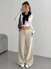 Beige wide leg corduroy pants with a relaxed fit and front pockets made of soft corduroy fabric