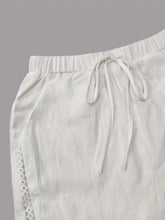 White linen wide leg cropped pants with elastic waistband drawstring and delicate eyelet lace trim on side seam
