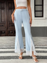 Light blue high-waisted flare leg pants with white lace trim at the cuffs featuring lace trim detailing