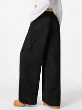 Black wide leg corduroy drawstring pants with a relaxed high waisted fit in soft corduroy fabric