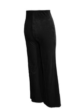 Black high waist velvet flare pants with wide-leg cut and smooth slightly reflective fabric for elegant wear