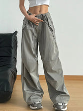 Gray wide leg drawstring pants with relaxed fit and multiple pockets made of durable cargo fabric