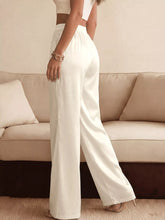 White satin high-waisted wide-leg pants featuring a lace waist detail for an elegant and modern look
