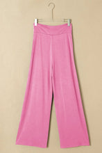 Pink knotted waist split leg relaxed pants with high waist and smooth flowing fabric for comfortable wear