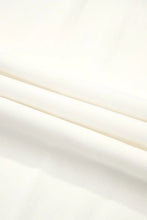 Flowy wide leg pants in soft off-white fabric with smooth texture and subtle folds featuring a drawstring waist