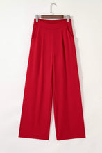 Red pleated detail pull on high elastic waist loose straight pants with ribbed elastic waist and side pockets on wooden hanger