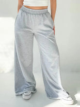 Light gray heathered sweatpants with elastic waist wide and flowing wide leg design for comfortable wear