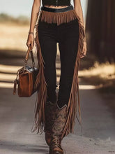 Brown fringe hem slim fit pants with black waistband paired with matching cowboy boots for a stylish look