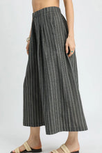 Black and white vertically striped umgee pinstripe crop palazzo pants with pleated waistband and cropped ankle length