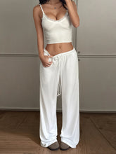 White satin relaxed wide leg pants with a drawstring waist and subtle side pockets for comfortable wear