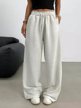Light gray wide leg drawstring sweatpants with elastic waistband suitable for casual wear care instructions included