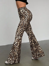Leopard print high waist flare pants in stretchy form-fitting fabric with bold brown and black spots on cream base
