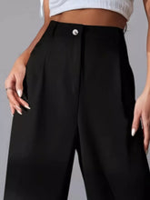 Black high-waisted wide leg pleated pants with a tailored fit and single silver button at front waistband