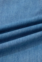 Blue denim chambray pants with ruffled hem wide leg design featuring soft worn texture and subtle stitching details