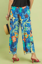 Umgee floral print wide leg pants in vibrant blue with tropical orange teal and green flowers and turtles on flowing fabric