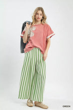Pink short-sleeved top with beige butterfly appliqué paired with umgee vertical stripe wide leg pants