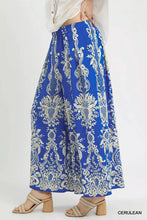 Umgee border print wide leg pants in vibrant cerulean with intricate white floral pattern and lightweight flowing fabric