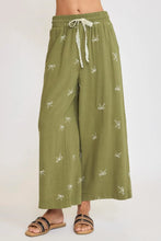 Olive green umgee plus size wide leg pants with lace drawstring embroidered white bow pattern and elastic waistband