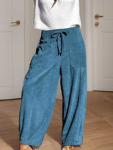 Blue corduroy wide leg pants with a drawstring waist and large front pockets for casual corduroy wide style