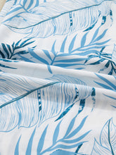 White fabric tropical print shirred waistband wide leg pants with vibrant blue tropical leaf pattern and brushstroke accents