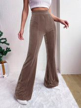 Brown corduroy high waist flare pants with ribbed texture and subtle vertical stripes in a high waist design