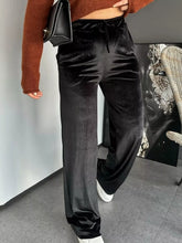 Black velvet wide leg pants with high waist and drawstring waistband for a comfortable fit