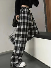 Black and white plaid high waist wide leg pants with elastic waistband and drawstring for comfortable fit