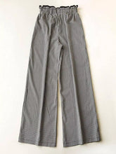 Gingham high-waisted wide-leg pants in black and white gingham pattern with ruffled elastic waistband