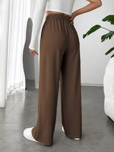Brown wide leg high waist pants with elastic waistband and smooth flowing fabric for stylish comfort