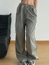 Gray wide leg drawstring pants featuring a drawstring waist and multiple pockets for casual wear