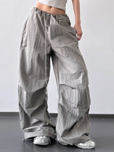 Silver metallic drawstring wide leg cargo pants with zipper pockets and a comfortable drawstring waist