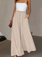 Beige high waist wide leg pants with button front closure and side pockets in a maxi skirt style
